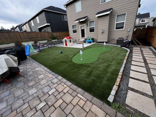 Artificial turf with putting green and paver installation