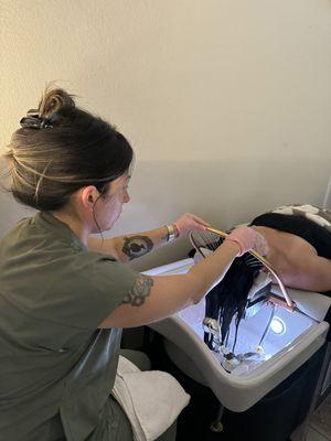 jessie working on a custom hair facial