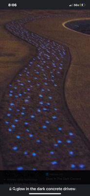 GlowCrete sprinkles light up a sidewalk after the sun has set.