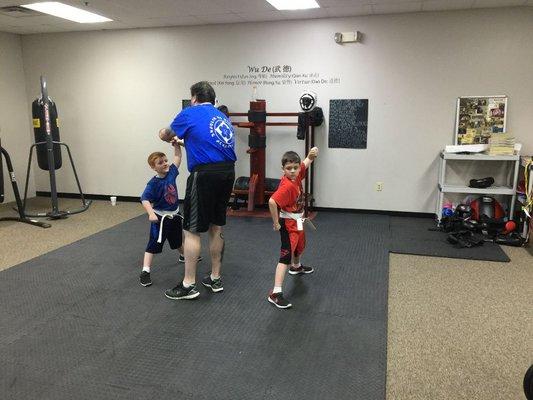 Our first two kid's class students learning their first form from Master Gaw.