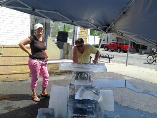 Lori and Randy Gericke coolin' off by the Avenue Auto ice sculpture on River Park Day 2012