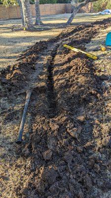 Digging a trench for an electric line for a backyard ADU at 20" deep