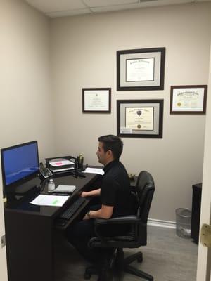 Dr. Medina's work area and certifications.