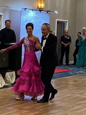 My wife and I at Caruso Dancesport showcase 2019. Angelo Caruso proudly looking on, back left