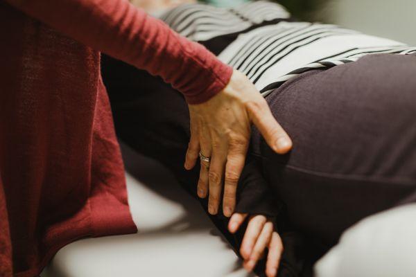 One-on-one somatic education sessions take place on a therapy table. You are guided verbally and by touch into gentle movements.