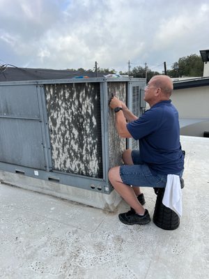 Combing out a conditioner coil due to damage from hail.