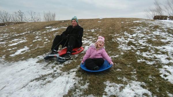 Thomas and Aaliyah Kelly sledding at the hill near Soldier Field.