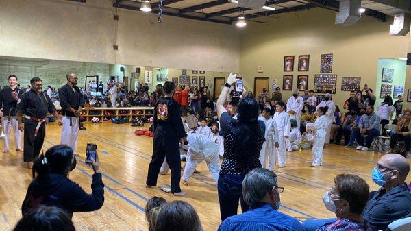 White belt breaking their first board with a hammer fist