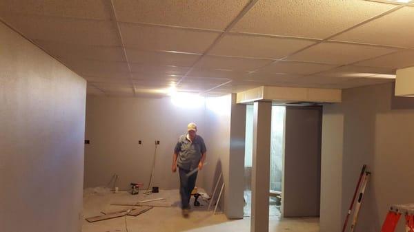 Finished ceiling with a look towards the bathroom. Drop down due to duct work and wrapped and dry walled support post