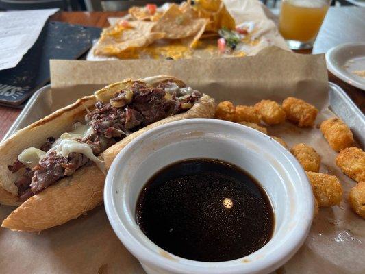 French dip sammie and some nachos in the background