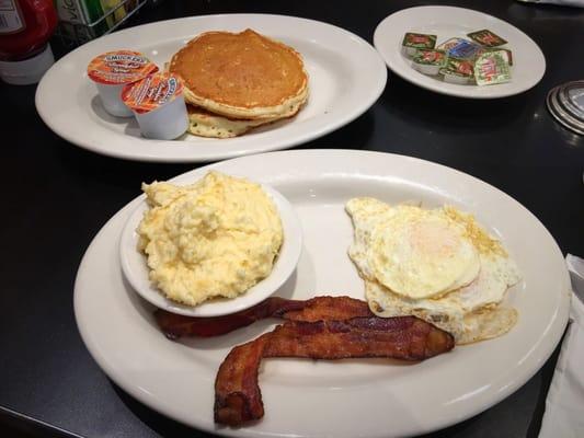 Early Bird Platter sub. pancakes for toast (cost extra), over medium eggs, bacon, and grits.