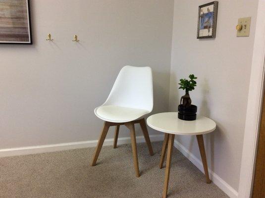 Chair and table plus hooks for clients clothes. Have a seat and tell me how I can help!