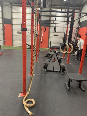 Power rack with turf strip in background- also, garage doors apparently are open during the warmer months