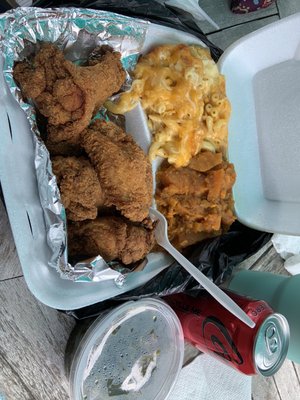 Fried chicken wings with Mac and cheese, sweet potatoes and collard greens.