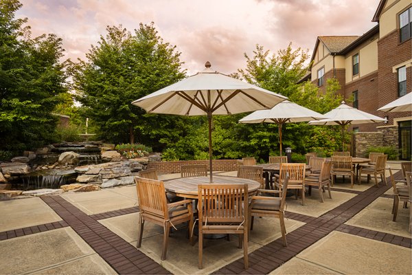 Outdoor dining patio beautifully landscaped with waterfall