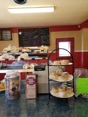 Breakfast sandwich names on chalkboard. Freshly made baked goods on display.