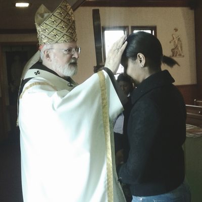 Parishioner receiving a blessing from Cardinal Seán when he came to say Mass!