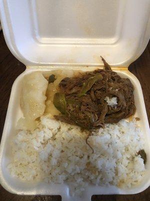 Ropa vieja with white rice and yuca.