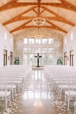 ceremony cross, rose petals, and greenery nooks