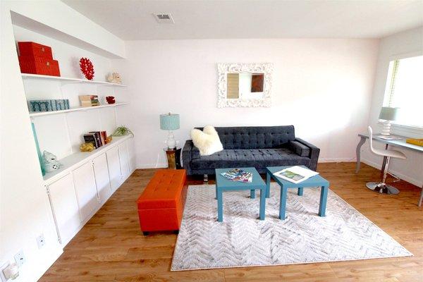 bright airy living space with custom built-in shelving & cabinets