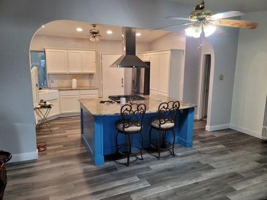 Complete Small kitchen remodel  with open floor design 95% done the island was custom built, painted, and granite installed. New wood floor