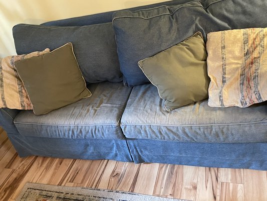 Faded and worn out couch (not as pictured on Sunset Rentals website)