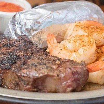 Who likes a good Surf & Turf? WE DO! 8oz. New York strip, fried jumbo Texas shrimp with a choice of baked potato or fries