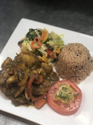 Jamaican curry chicken with rice and kidney beans with steamed vegetables