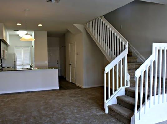 Our two bedroom apartments feature a banister-framed staircase and open floor plan.