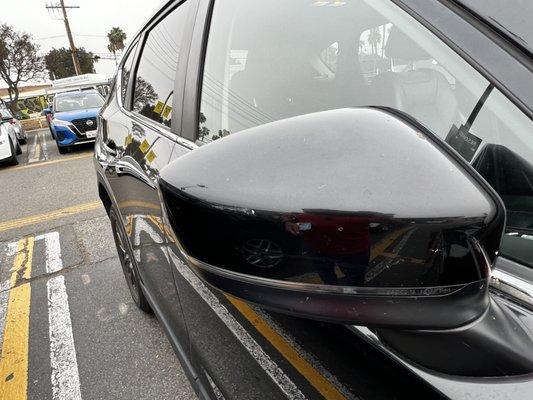 Scratches on the passenger side mirror.