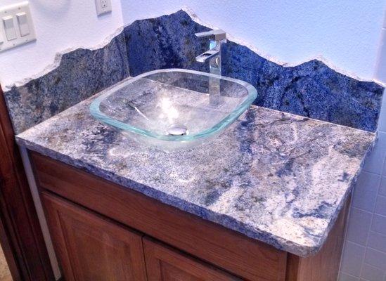 A  rock pitched edge was chosen for the vanity top and also for the backsplash to give the shape of mountains.