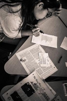 A student engages in a poetry workshop for middle school students.