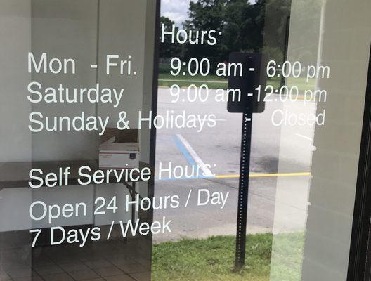 Hours of operation posted on front door.