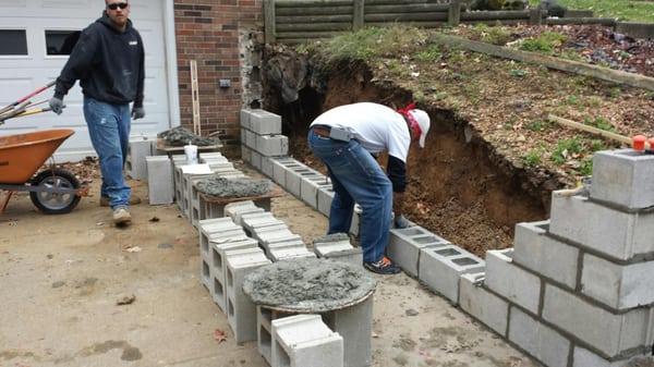 The old existing wall was caving in and ready to fall over.  The new wall was constructed included core fill and steel to ins...