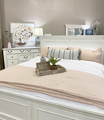 White farmhouse bed frame and chest.