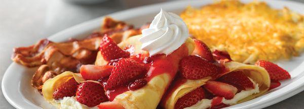 Strawberry Crepes Brunch - Two strawberries and cream Crêpes, served with hashbrowns and cherrywood-smoked bacon strips or sausage links