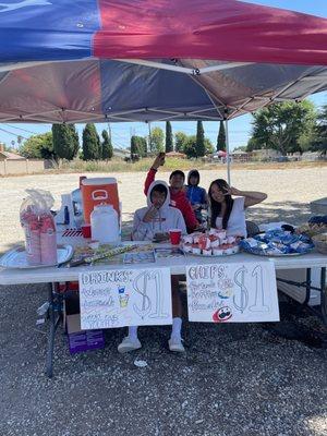 Youth members selling snacks after purchasing fireworks.