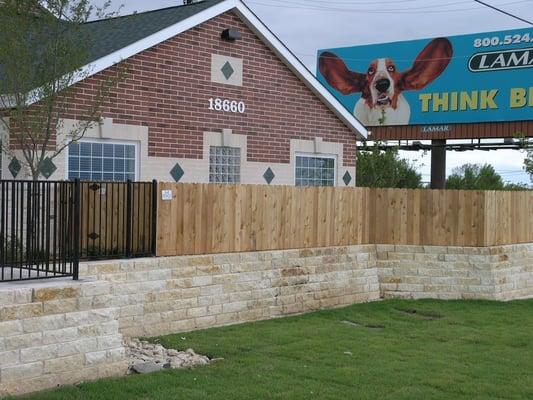 Combination Fence - Iron Fence with Wood Privacy Fence.  Christian Brothers Automotive. Buda, TX