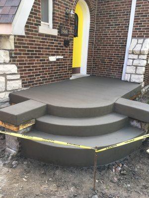 custom front porch and steps suspended over basement.