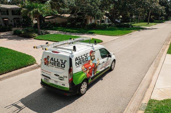 All U Need Pest Control van driving down the road.