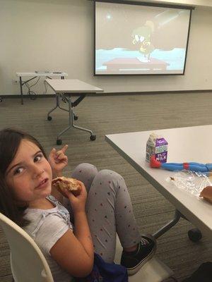 My daughter enjoying some lunch and Looney Tunes.