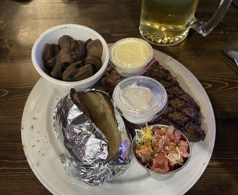 16oz ribeye w/loaded bake potato and mushrooms.