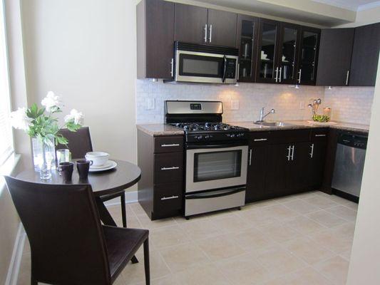 Kitchens feature stainless steel appliances, tile floors and modern cabinets.