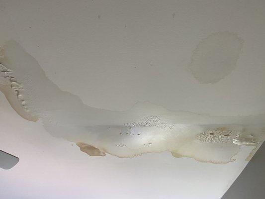 The living room ceiling is destroyed by water damage.