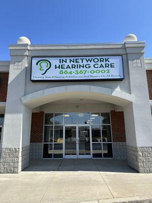 Sidewalk view of the office and sign