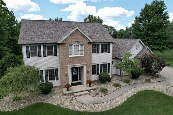 Owens Corning Duration Summer Harvest Shingles, Sand siding and brown gutters give this home in Green and total facelift.