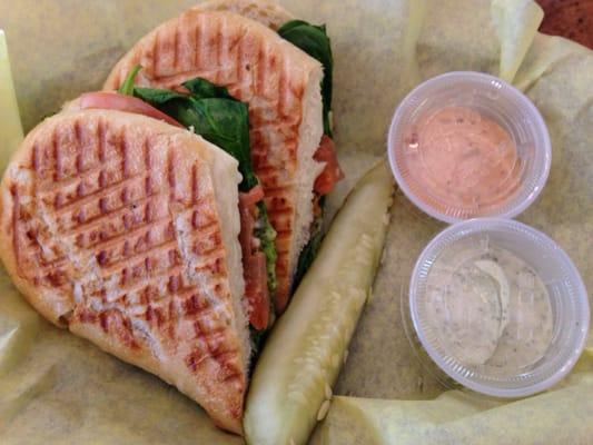 Caprese hot grilled panani with a side of aioli sauce and something else (spinach, fresh mozzarella, tomato, basil pesto on demibaguette) $6