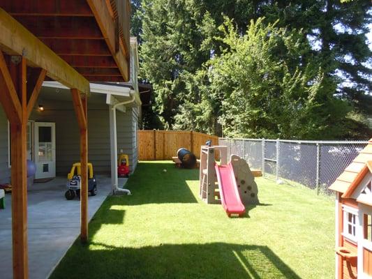 Outdoor play area, with sand box, playhouse ride in cars and trucks.