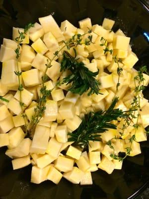 Cubed Manchego cheese covered with Garlic EVOO & a few sprigs of thyme & rosemary.