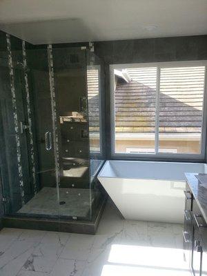 Floor and walls of a fully customized bathroom.